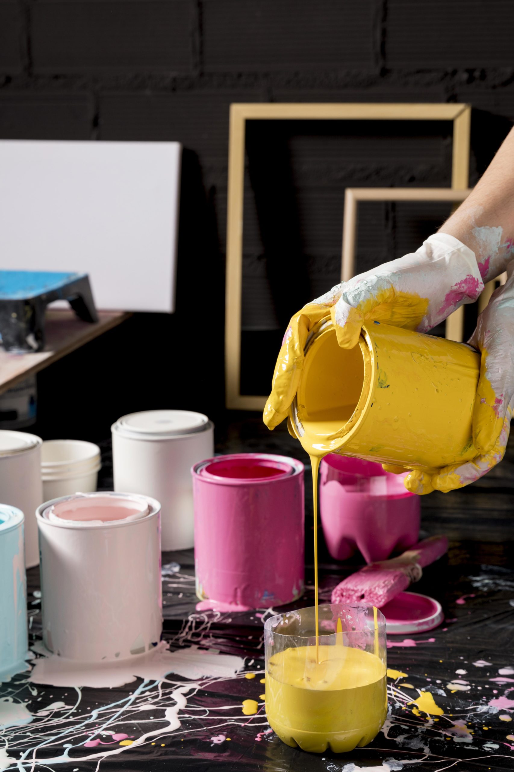 artist-mixing-paint-from-cans